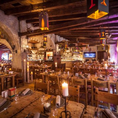 Medieval-style interior of the Castillo restaurant with plenty of seating.