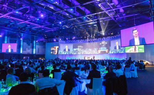 A presentation on a large stage featuring several LED screens at the Confertainment Centre in the Europa-Park Resort.