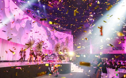 A stage show featuring golden confetti and pink lighting at the Confertainment Centre in Europa-Park.