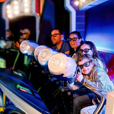 A family is sitting in a car on the GRAND PRIX EDventure attraction in the Luxembourg themed area of Europa-Park.